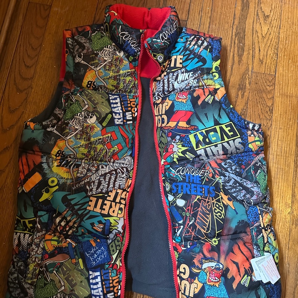 Reversible Nike SB Red/Blue Puffer Vest. Comic print on reverse. Big boys large.
